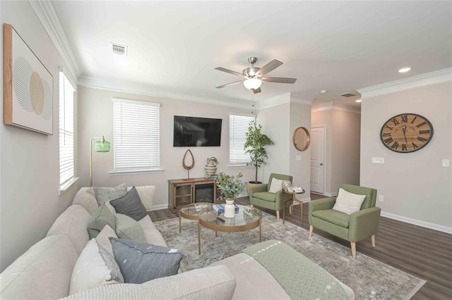 living room with crown molding, wood-type flooring, and ceiling fan