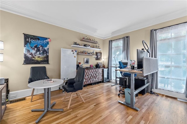 office featuring light wood-style flooring, crown molding, and baseboards