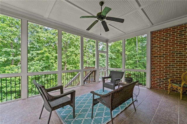 sunroom featuring a ceiling fan and healthy amount of natural light