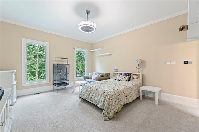 carpeted bedroom with crown molding and baseboards