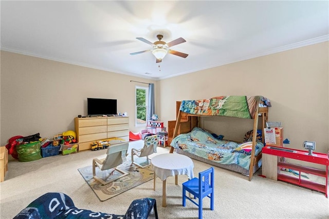 bedroom featuring carpet flooring, ornamental molding, and a ceiling fan