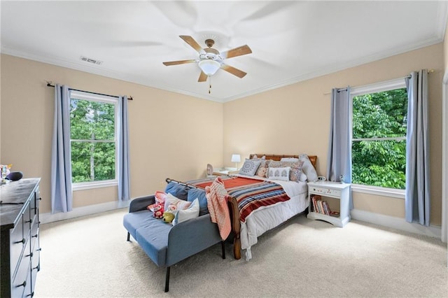 bedroom featuring light carpet, multiple windows, baseboards, crown molding, and a ceiling fan