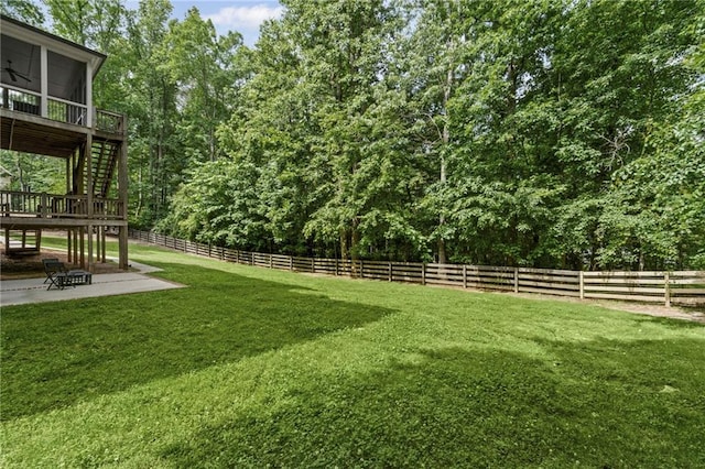 view of yard with stairs, a wooden deck, and a patio area