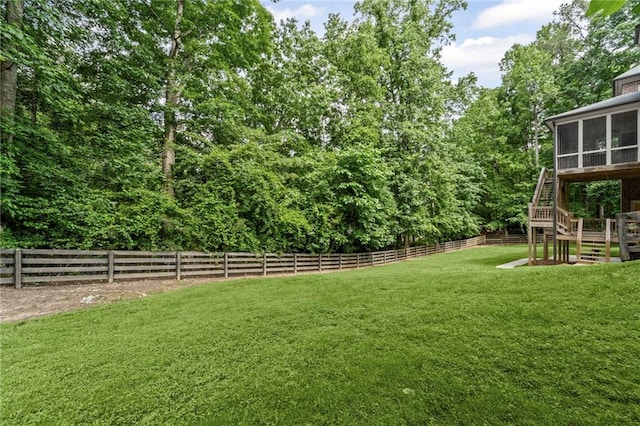 view of yard with a sunroom and stairway