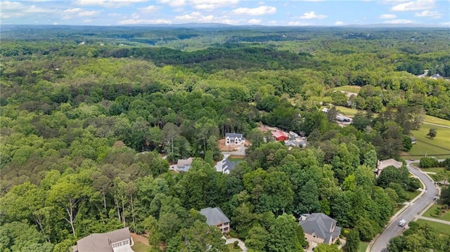 aerial view of property's location with a heavily wooded area