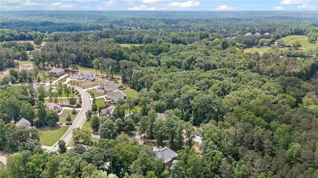 aerial view of property's location featuring a forest