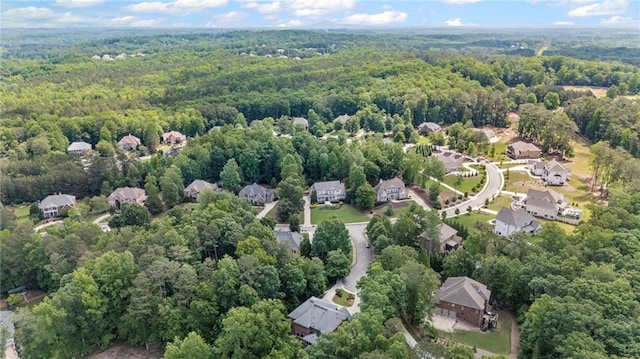 aerial view of property's location featuring a heavily wooded area