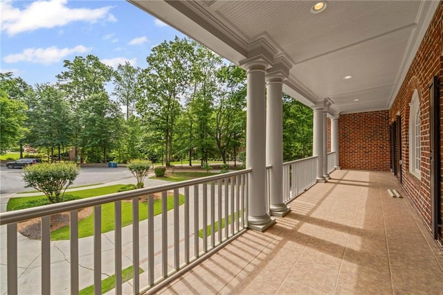 balcony with a porch and view of scattered trees
