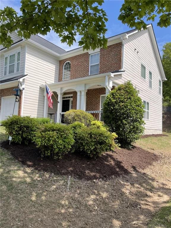 view of front of home with a porch and a garage