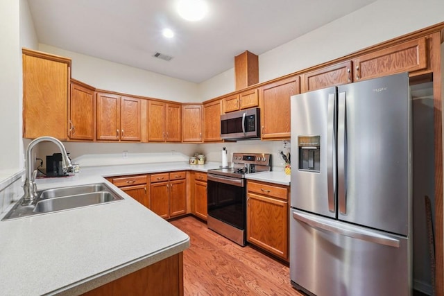 119 Holiday Rd, Unit Buford, GA 30518 - kitchen with appliances with stainless steel finishes, light wood finished floors, light countertops, and brown cabinetry