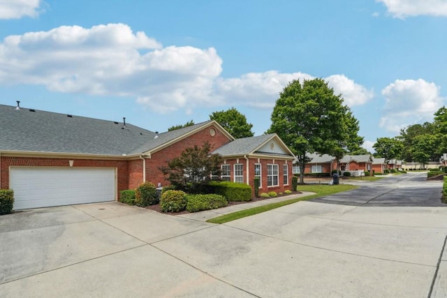 119 Holiday Rd, Unit Buford, GA 30518 - view of front facade with brick siding, driveway, an attached garage, and a shingled roof