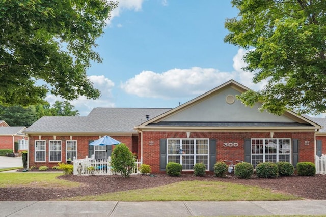 119 Holiday Rd, Unit Buford, GA 30518 - view of front of house featuring brick siding and a front lawn