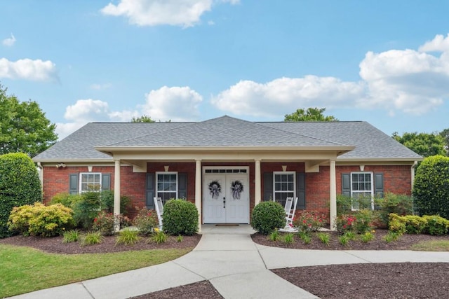 119 Holiday Rd, Unit Buford, GA 30518 - view of front of home featuring brick siding, roof with shingles, and covered porch