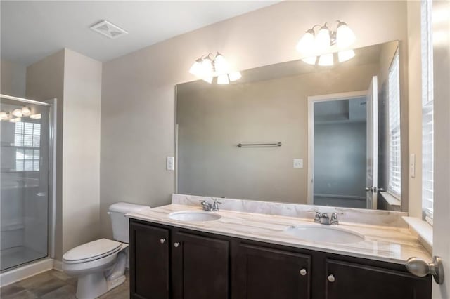 bathroom featuring vanity, an enclosed shower, tile patterned floors, and toilet