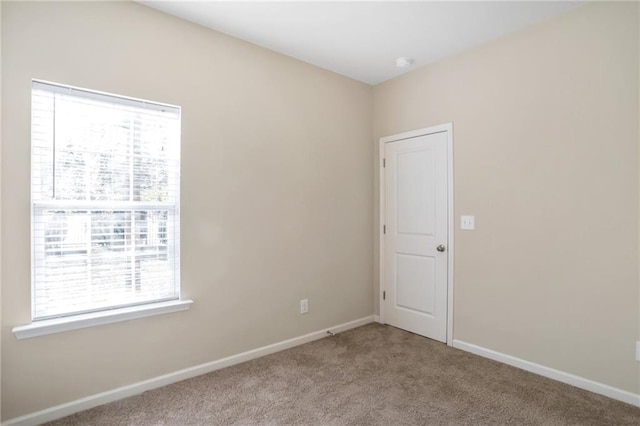 unfurnished room featuring light colored carpet