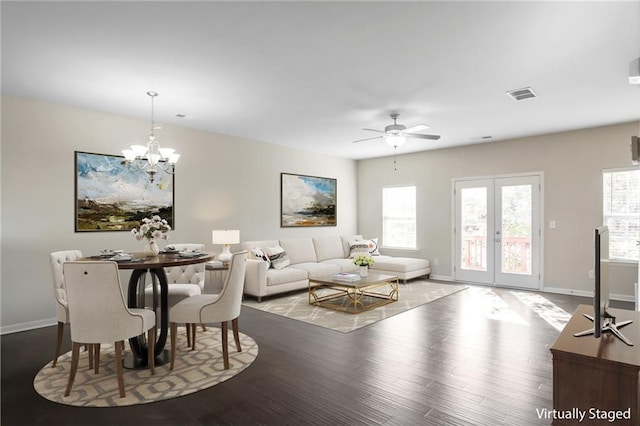 living room featuring hardwood / wood-style flooring, ceiling fan with notable chandelier, and french doors