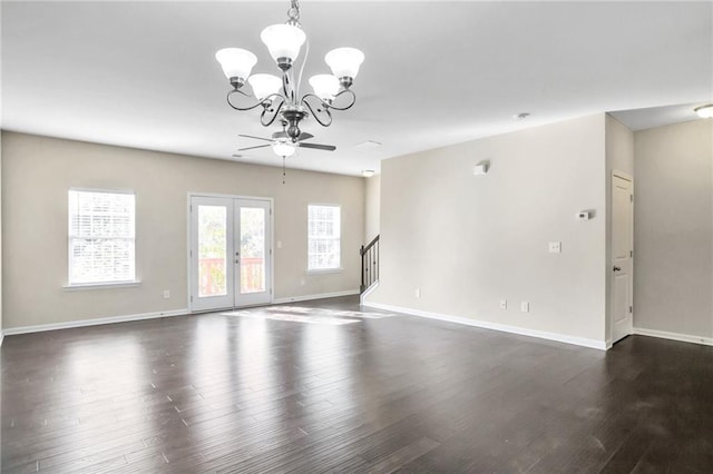 unfurnished room with ceiling fan with notable chandelier, dark hardwood / wood-style flooring, and french doors