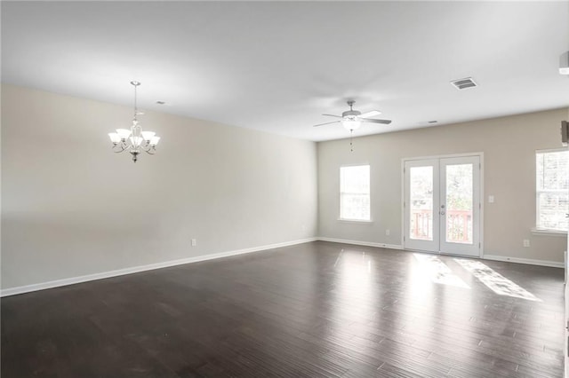 empty room featuring dark hardwood / wood-style floors and ceiling fan with notable chandelier