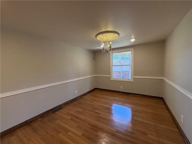 2807 Mcclave Dr, Doraville, GA 30340 - spare room with a chandelier, wood finished floors, and baseboards