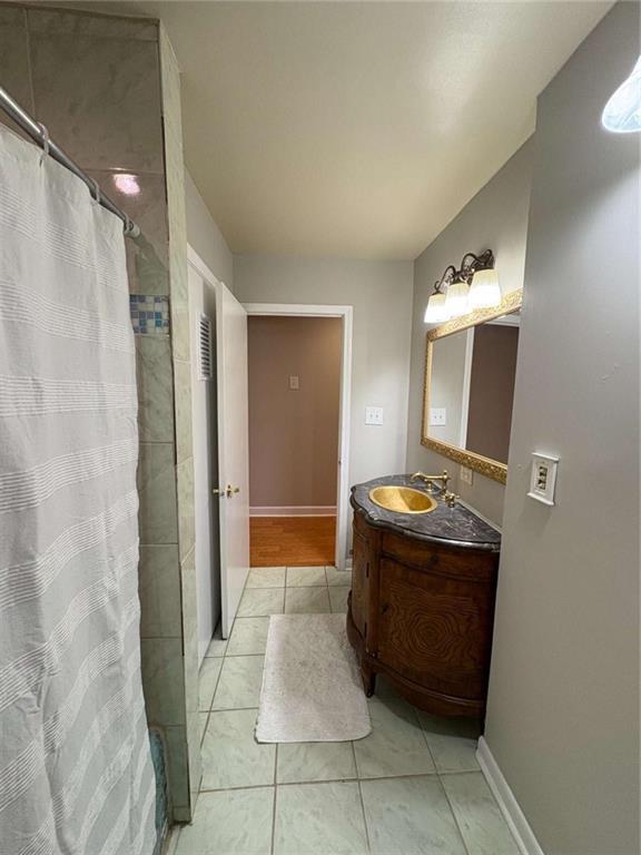 2807 Mcclave Dr, Doraville, GA 30340 - full bath with vanity, a shower with shower curtain, tile patterned flooring, and baseboards