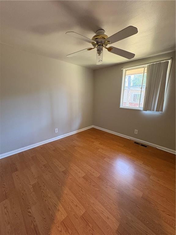 2807 Mcclave Dr, Doraville, GA 30340 - spare room featuring a ceiling fan, wood finished floors, and baseboards