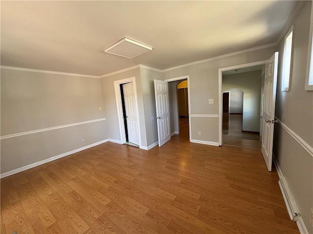 2807 Mcclave Dr, Doraville, GA 30340 - spare room featuring arched walkways, wood finished floors, crown molding, and baseboards