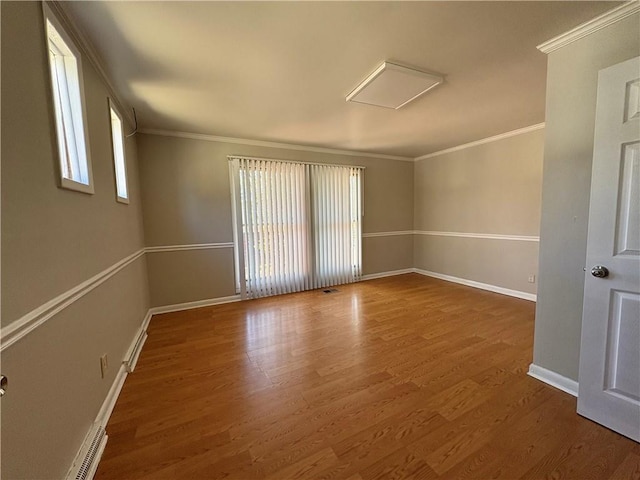 2807 Mcclave Dr, Doraville, GA 30340 - spare room with crown molding, wood finished floors, baseboards, and attic access