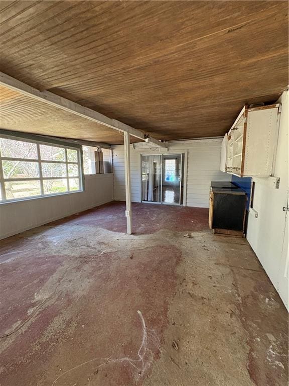 2807 Mcclave Dr, Doraville, GA 30340 - unfurnished living room with wood ceiling and concrete flooring