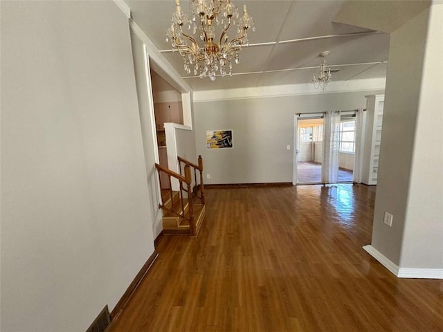 2807 Mcclave Dr, Doraville, GA 30340 - hallway with a chandelier, baseboards, wood finished floors, and stairway