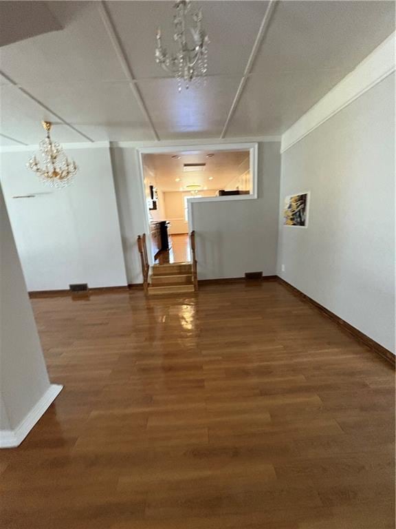 2807 Mcclave Dr, Doraville, GA 30340 - unfurnished room with a chandelier, baseboards, and wood finished floors