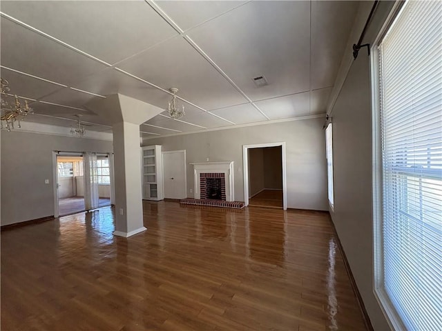 2807 Mcclave Dr, Doraville, GA 30340 - unfurnished living room with wood finished floors, a brick fireplace, and baseboards