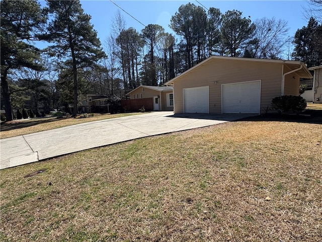 2807 Mcclave Dr, Doraville, GA 30340 - view of property exterior with concrete driveway, an attached garage, and a lawn
