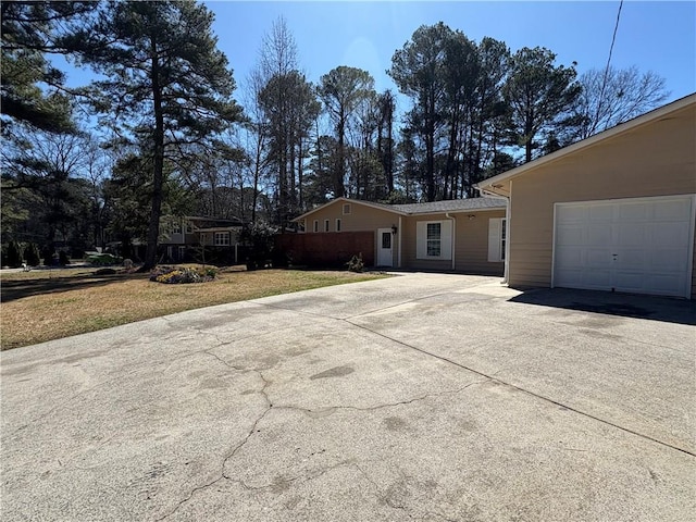 2807 Mcclave Dr, Doraville, GA 30340 - ranch-style home with concrete driveway, a front yard, and an attached garage