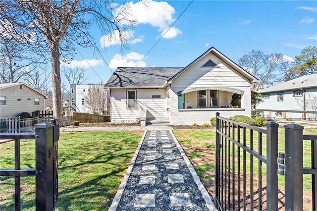 bungalow-style home featuring brick siding, a front lawn, and fence