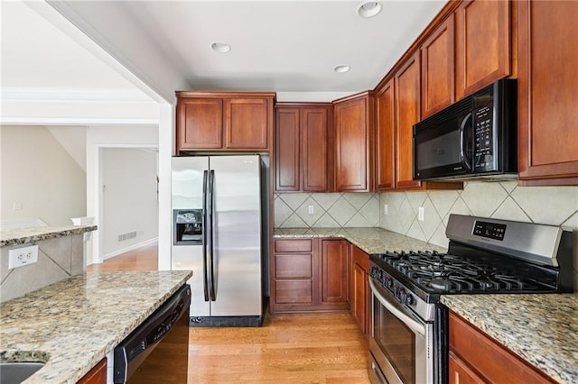 626 Pecan Knoll Dr Unit 13, Marietta, GA 30008 - kitchen with black appliances, tasteful backsplash, light wood-type flooring, light stone counters, and recessed lighting