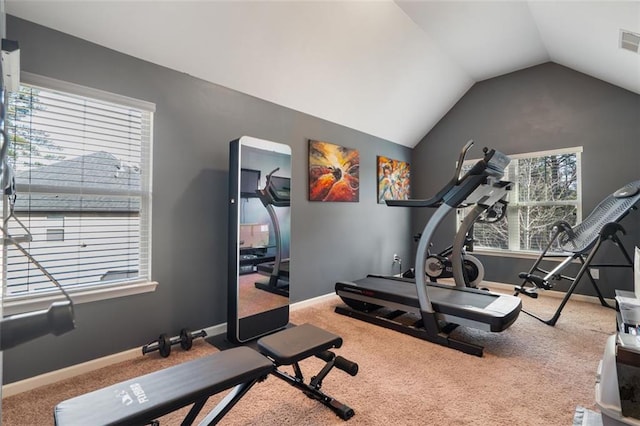 exercise room featuring vaulted ceiling and carpet flooring