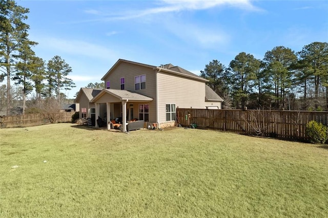 back of house featuring a patio area and a lawn