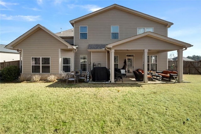 back of property with a patio and a yard