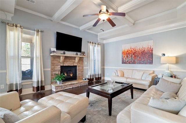 living room featuring crown molding, beam ceiling, coffered ceiling, wood-type flooring, and a stone fireplace