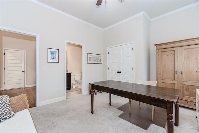 office with ornamental molding, light carpet, baseboards, and ceiling fan