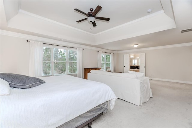bedroom featuring a raised ceiling, light colored carpet, ornamental molding, ceiling fan, and baseboards