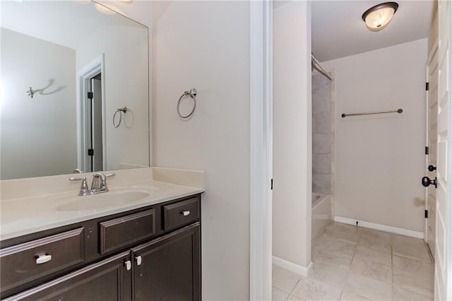 bathroom featuring vanity, tub / shower combination, baseboards, and marble finish floors