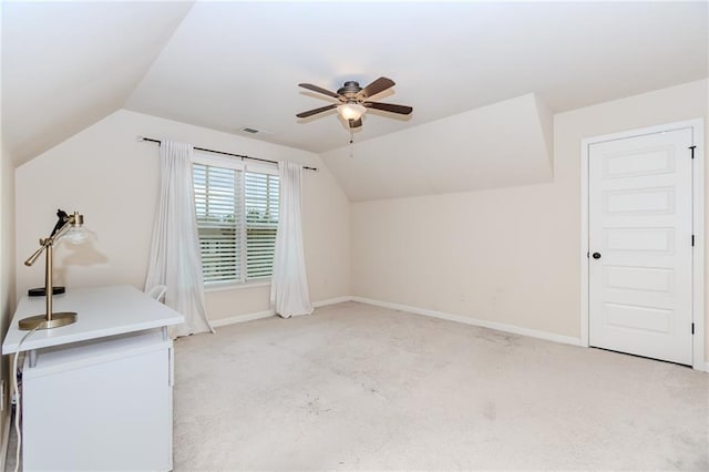additional living space featuring a ceiling fan, lofted ceiling, light colored carpet, and baseboards