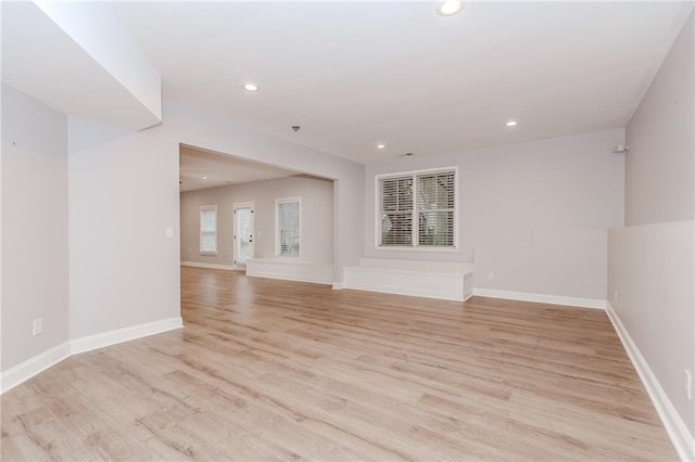unfurnished room with recessed lighting, light wood-style floors, and baseboards