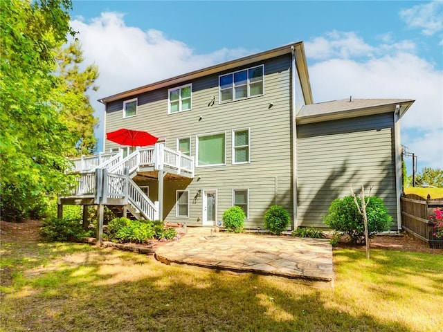 rear view of house featuring stairs, a wooden deck, and a patio