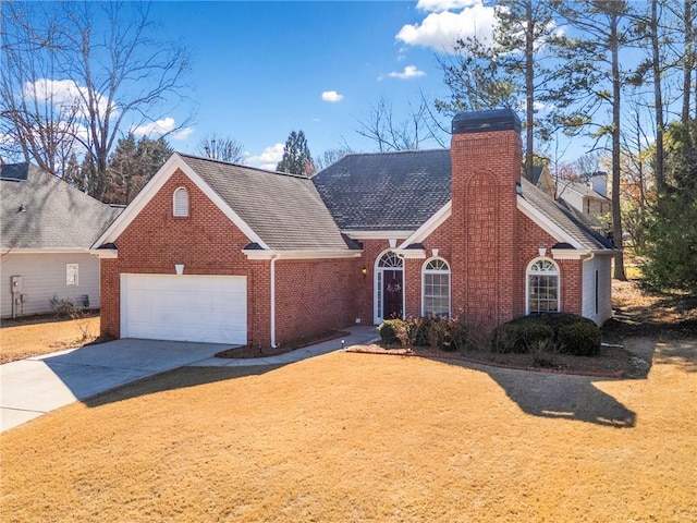 view of front of property featuring a front yard, an attached garage, a chimney, concrete driveway, and brick siding