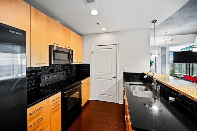 kitchen with sink, dark stone countertops, black appliances, dark wood-type flooring, and light brown cabinets