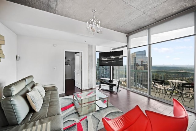 living room with expansive windows, a notable chandelier, and wood finished floors