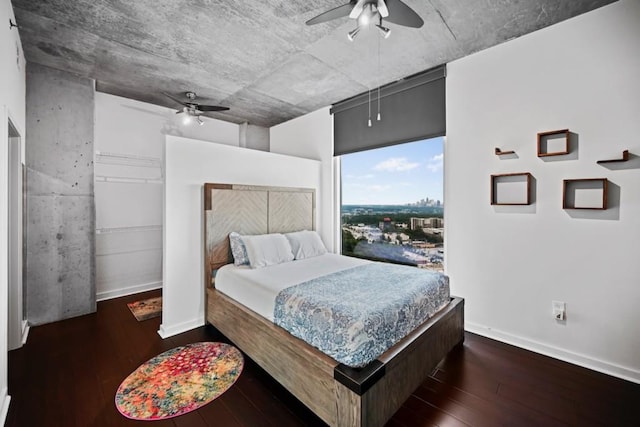 bedroom featuring hardwood / wood-style flooring, baseboards, and ceiling fan