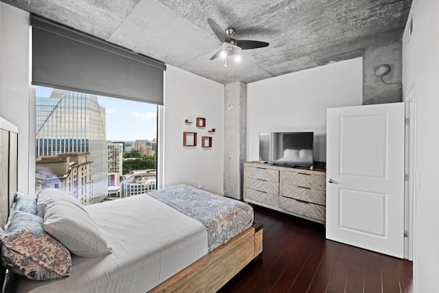 bedroom with dark hardwood / wood-style flooring and ceiling fan